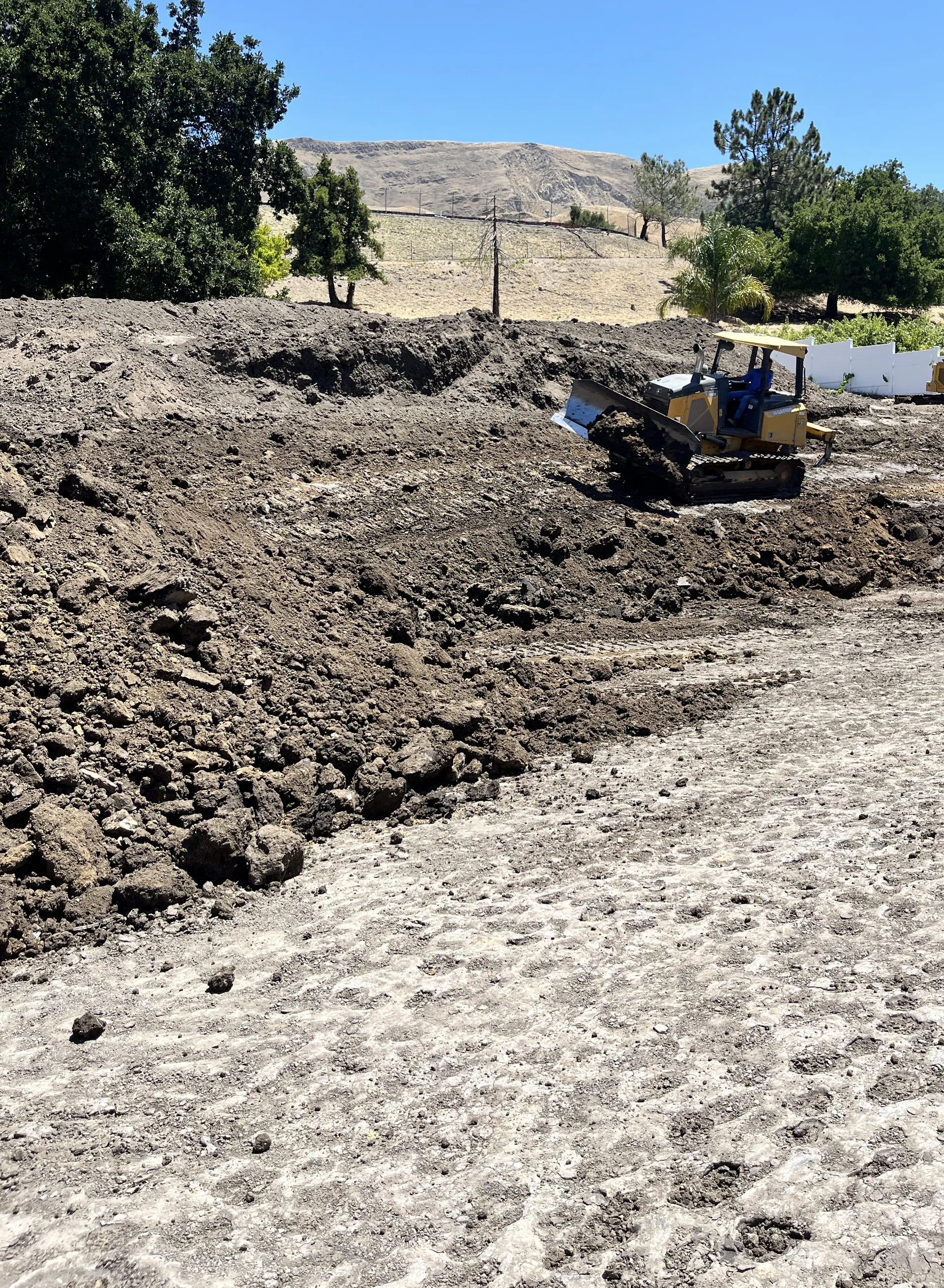 Hillside building pad being rebuilt in compacted layers