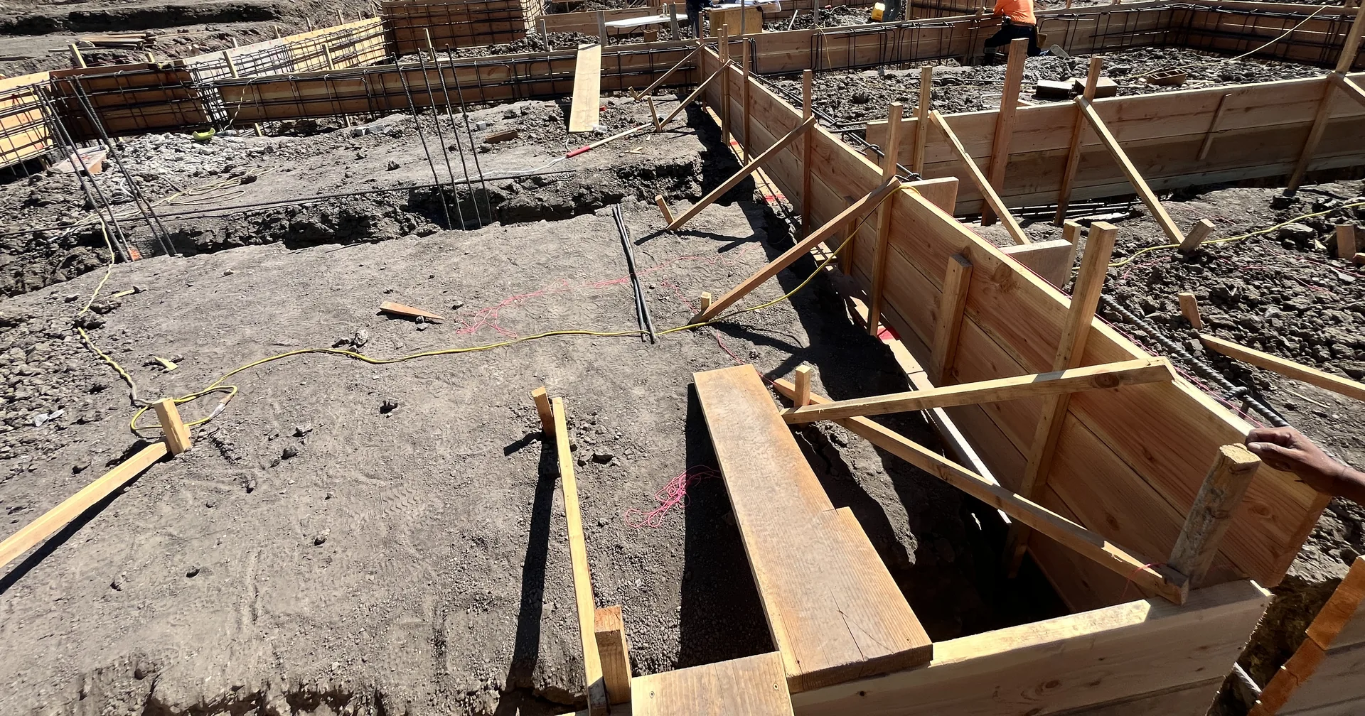 Stepped grade beam forms and reinforcing steel on a hillside building pad