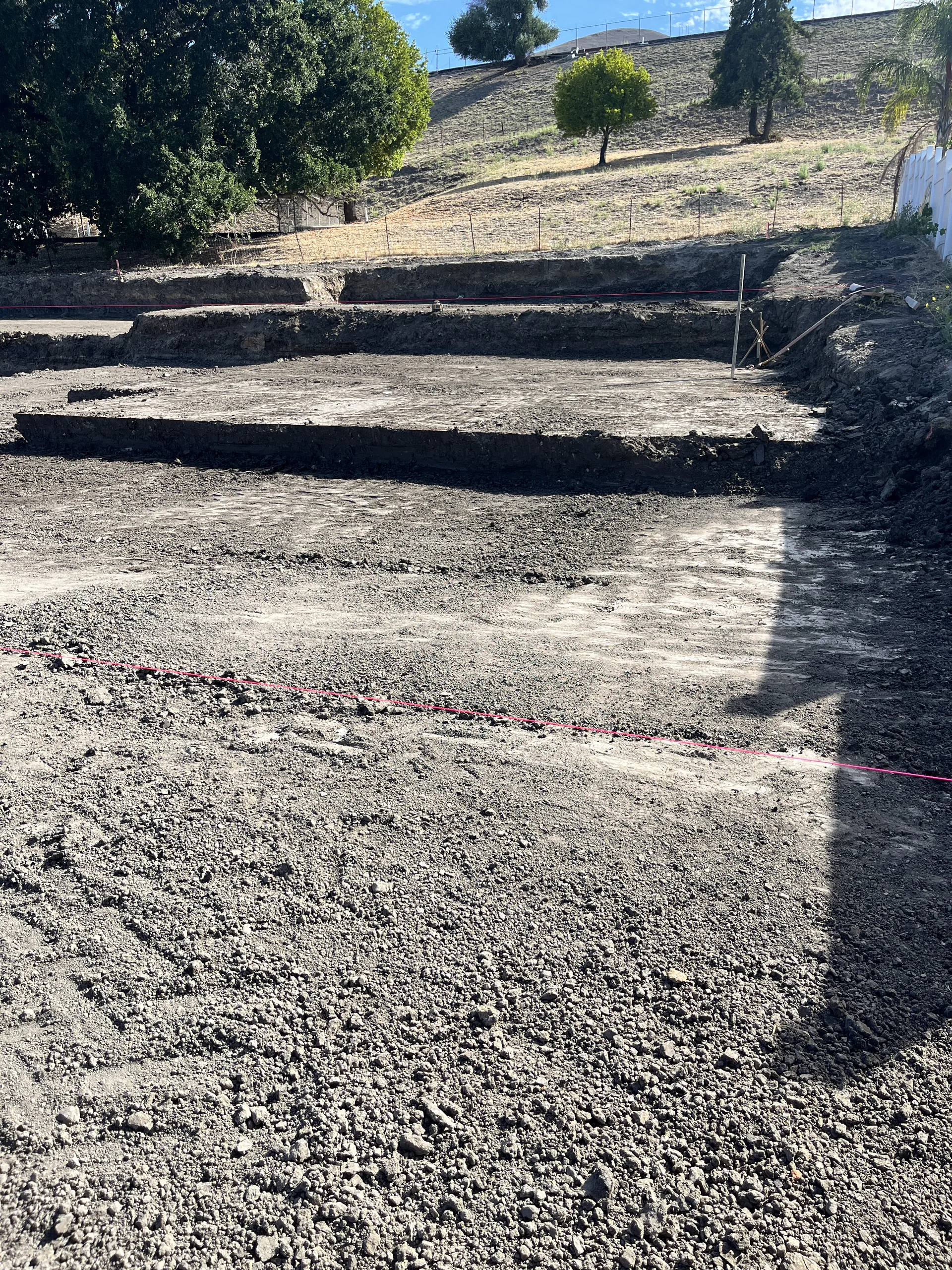 Finished hillside building pad graded into stepped benches
