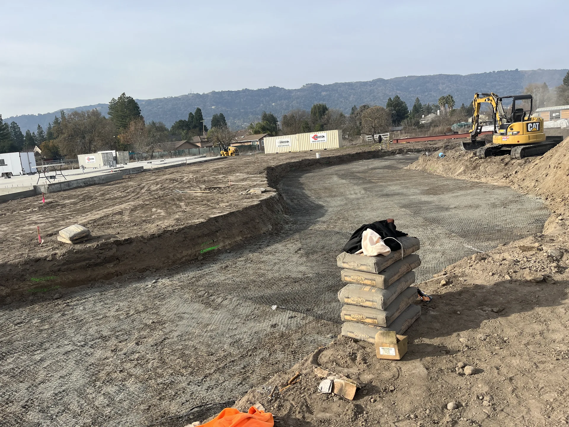 Fire access road bed with geogrid and cement bags over liquefied soil
