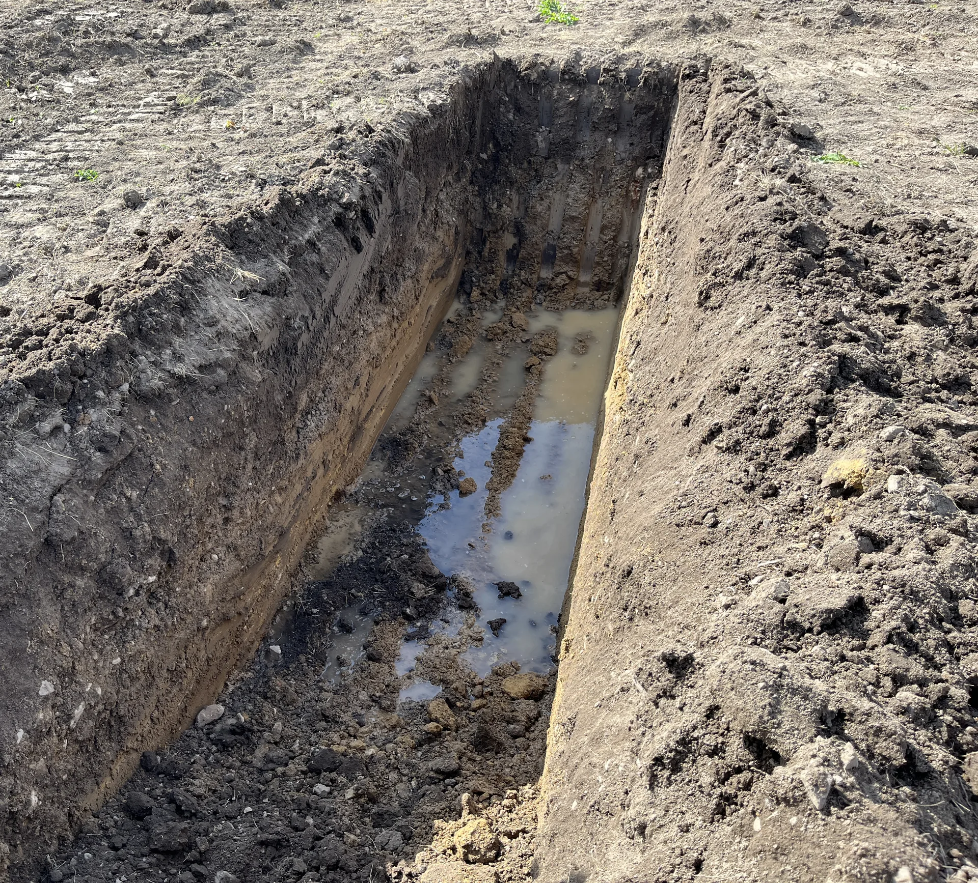 Test trench on a Pleasanton custom home site with groundwater standing in the bottom