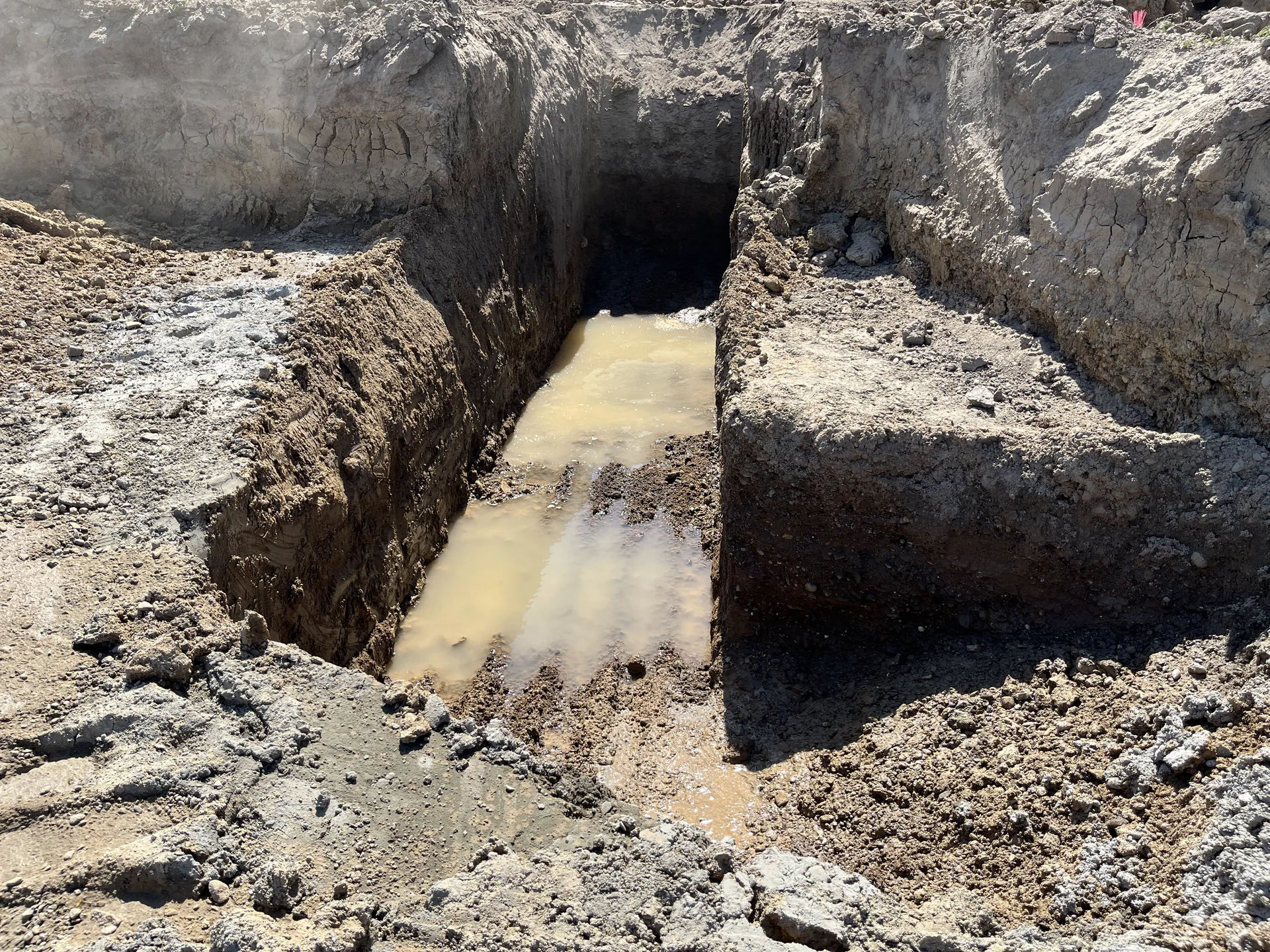 Water seeping into a freshly dug trench where the soil had liquefied