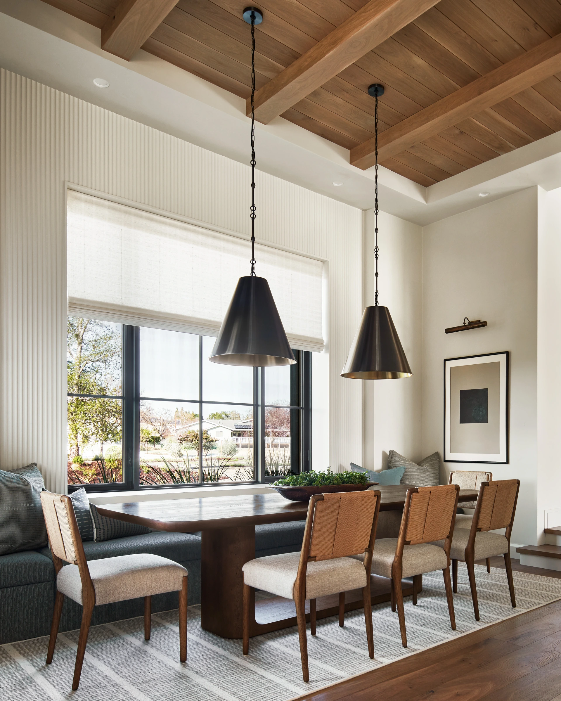 Breakfast nook in a Pleasanton custom home with a custom upholstered bench and RH table
