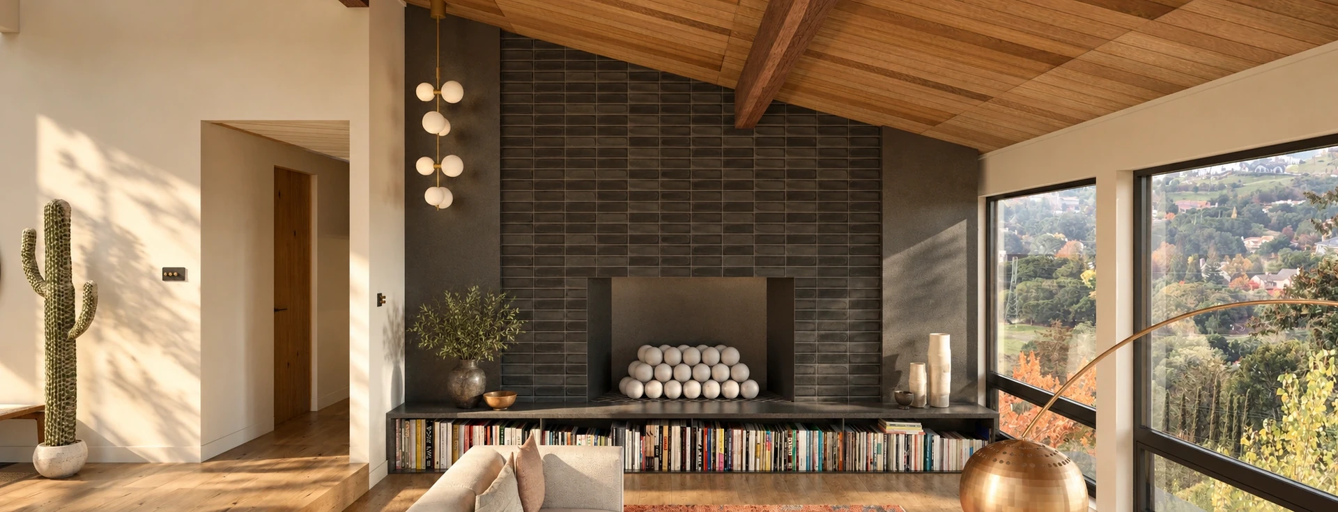 Living room with a charcoal tile fireplace, book-lined raised hearth and wood plank ceiling